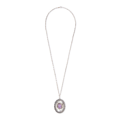 Magnificent Scottish sterling silver pendant centred with a large oval amethyst in a claw setting, with scroll work on the edges. The pendant hangs from an 82.1cm sterling silver fancy link chain.
