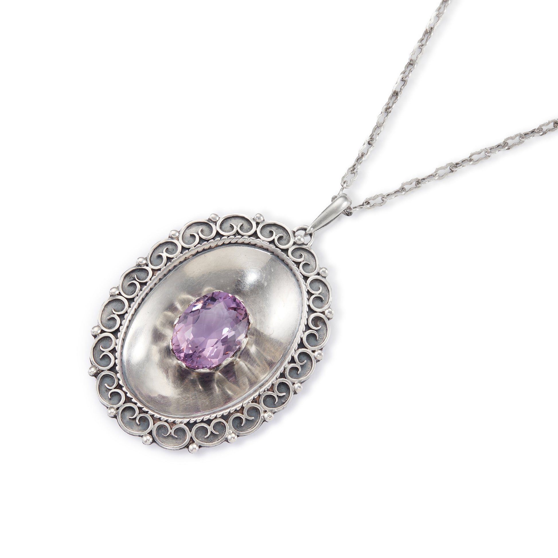 Magnificent Scottish sterling silver pendant centred with a large oval amethyst in a claw setting, with scroll work on the edges. The pendant hangs from an 82.1cm sterling silver fancy link chain.