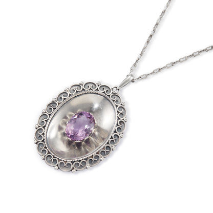 Magnificent Scottish sterling silver pendant centred with a large oval amethyst in a claw setting, with scroll work on the edges. The pendant hangs from an 82.1cm sterling silver fancy link chain.