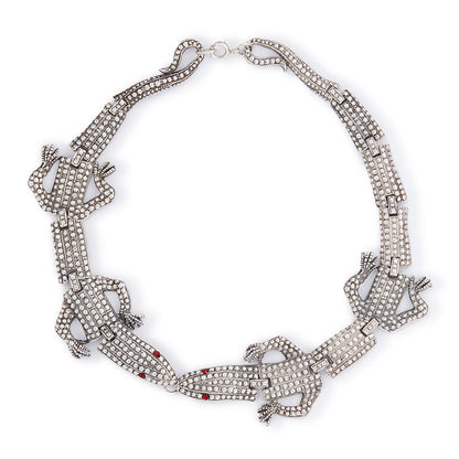 Highly sought after articulated sterling silver Butler and Wilson necklace consisting of two connected lizards with red paste eyes. The necklace can also be divided into a shoulder brooch and a 16cm bracelet, making this a very versatile and fun piece.