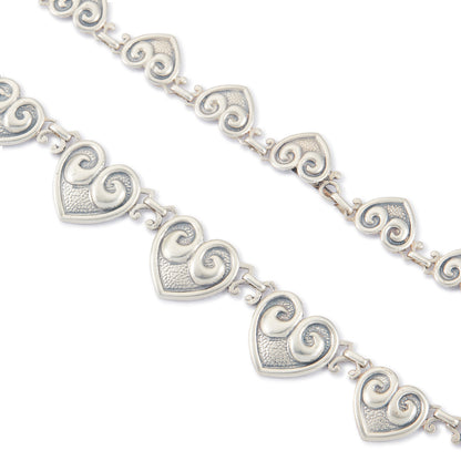 Classic sterling silver Candida choker consisting of fourteen linked repoussé hearts.

Hallmarked: Candida Sterling Silver