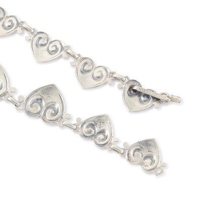 Classic sterling silver Candida choker consisting of fourteen linked repoussé hearts.

Hallmarked: Candida Sterling Silver