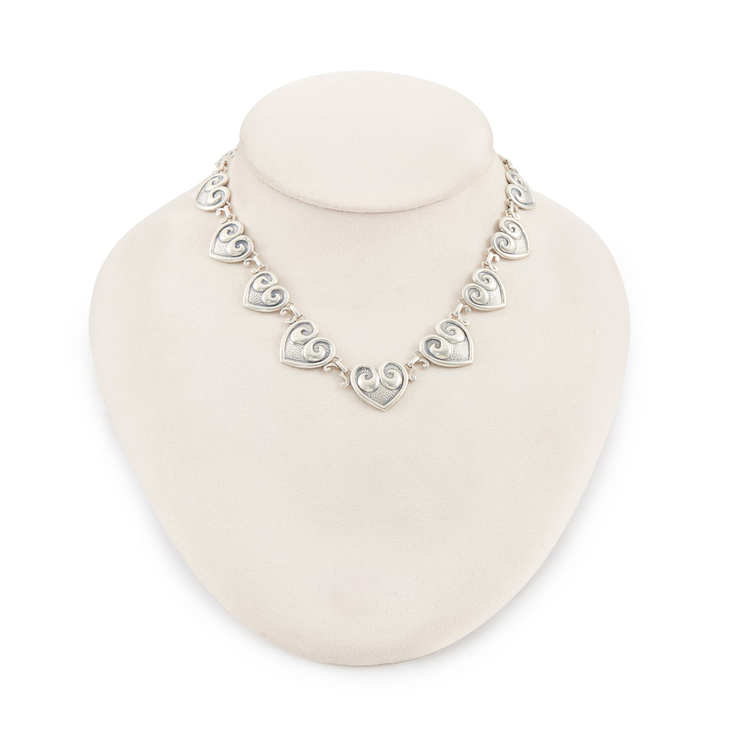 Classic sterling silver Candida choker consisting of fourteen linked repoussé hearts.

Hallmarked: Candida Sterling Silver