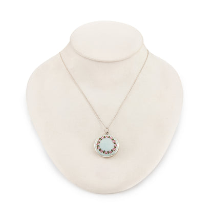 Pretty vintage sterling silver locket with an enamel floral design on a light blue background, on a sterling silver chain.