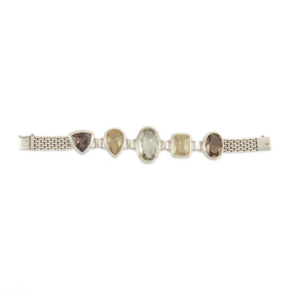 Stunning chunky sterling silver bracelet set with large, beautifully faceted citrine, smoky quartz and a green amethyst in the centre. The bracelet has a safety clasp.