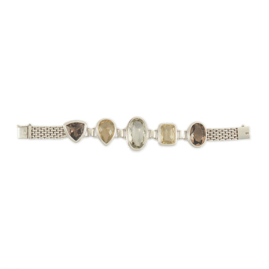 Stunning chunky sterling silver bracelet set with large, beautifully faceted citrine, smoky quartz and a green amethyst in the centre. The bracelet has a safety clasp.