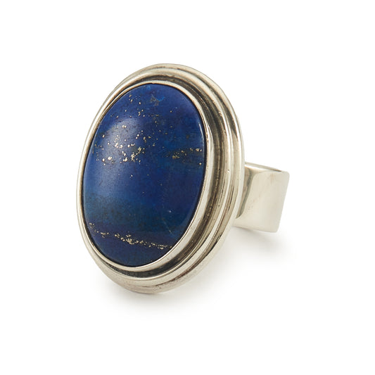 Stylish sterling silver ring with a large, deep-blue lapis lazuli cabochon in a tube setting.
