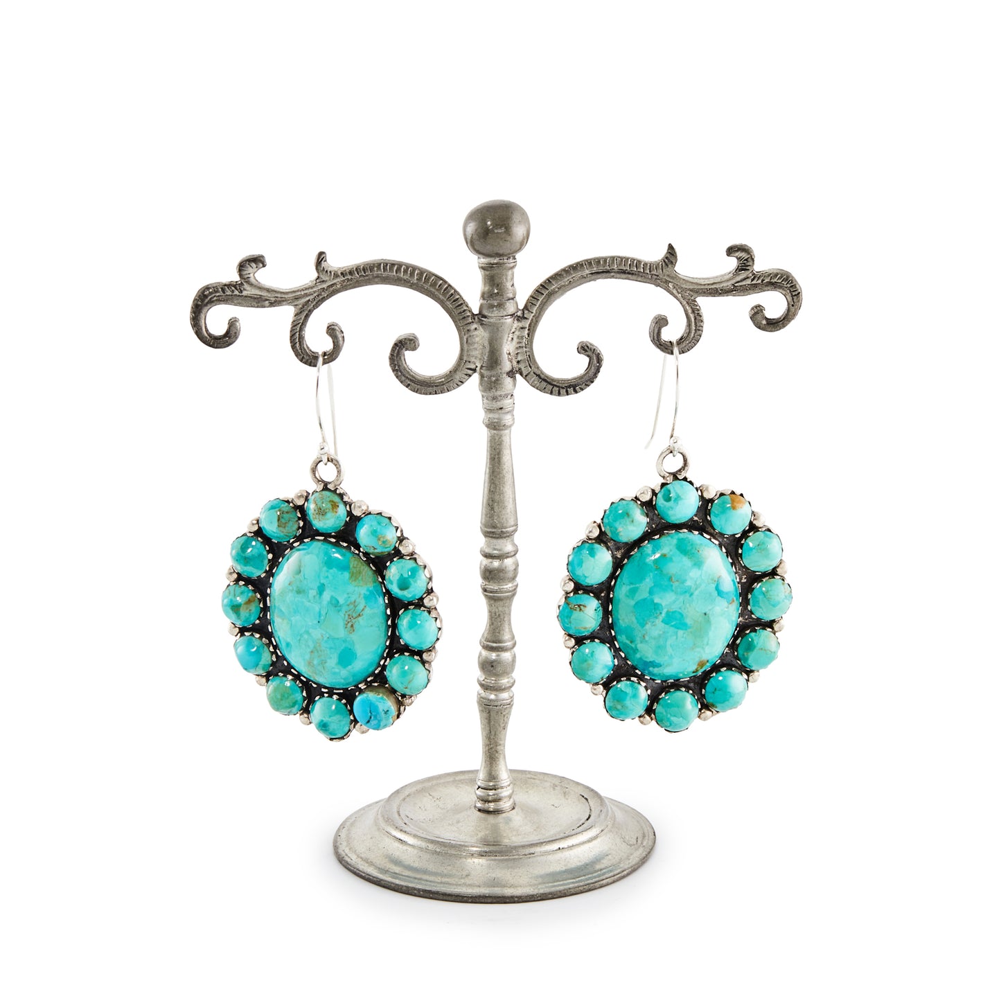 Stunning large handmade sterling silver Native American earrings with natural, vibrant turquoise stones in a cluster petit point setting.

Stamped “Sterling” with a feather marking.