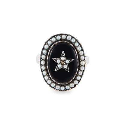 Lovely vintage sterling silver ring with an oval onyx stone, set with a star in the centre and a seed pearl surround.