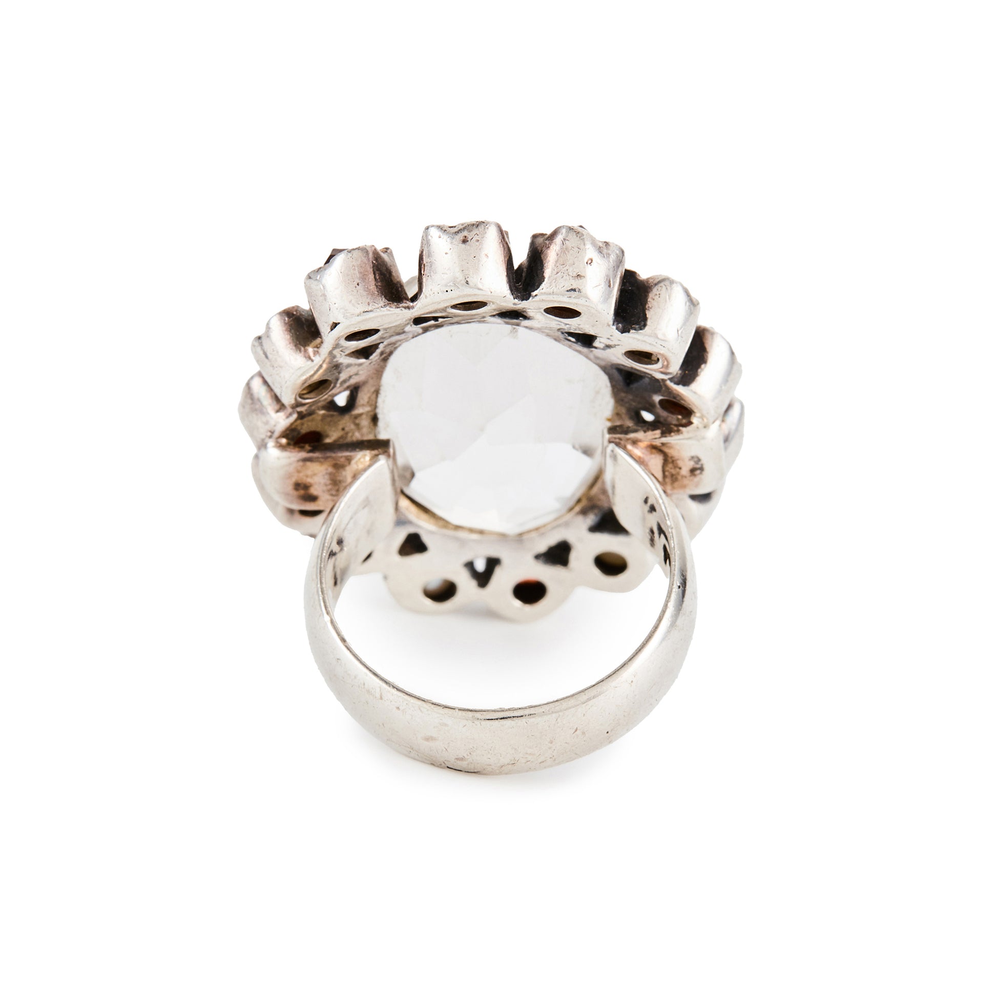 Glamorous sterling silver ring, with a faceted oval rock crystal stone surrounded by seven garnets and seven pearls in an oxidised silver setting.