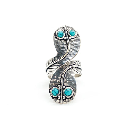 Charming handmade sterling silver snake ring with turquoise eyes. Size adjustable.