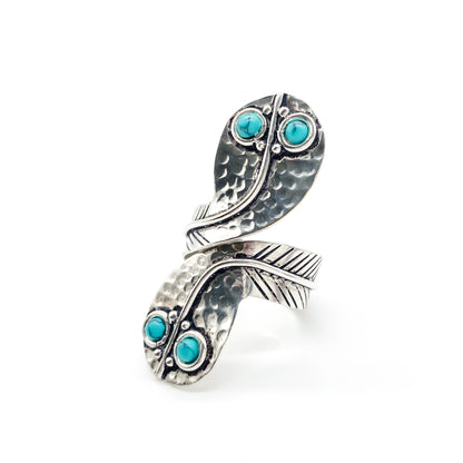 Charming handmade sterling silver snake ring with turquoise eyes. Size adjustable.