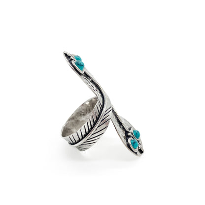 Charming handmade sterling silver snake ring with turquoise eyes. Size adjustable.