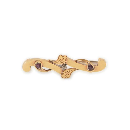 Dainty Victorian 15ct gold bar brooch set with two faceted rubies and a natural diamond in the centre.