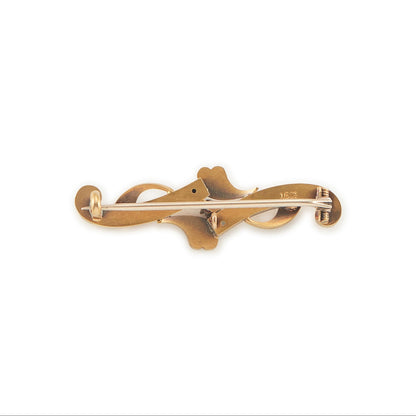 Dainty Victorian 15ct gold bar brooch set with two faceted rubies and a natural diamond in the centre.