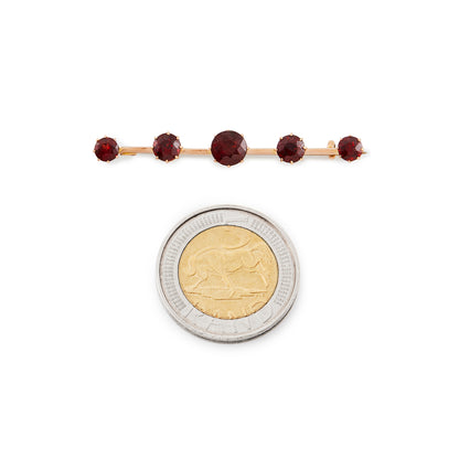 Classic 15ct rose gold Victorian bar brooch set with five beautifully faceted deep red garnets.