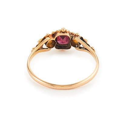 Delicate Victorian 15ct gold three stone ring set with two small opal cabochons and a faceted rhodolite garnet.