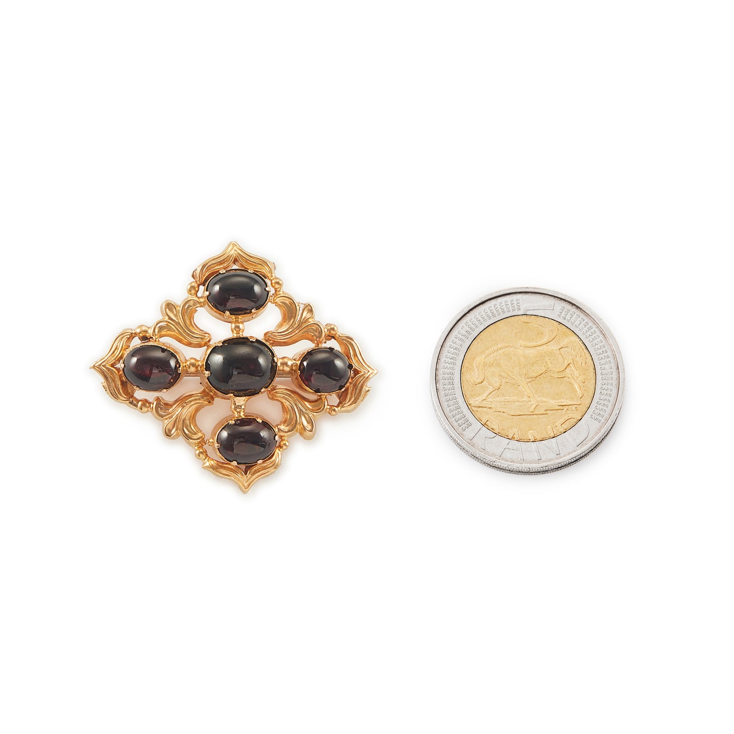 Beautiful Victorian repoussé brooch set with four cabochon Bohemian garnets. The piece can also be worn as a pendant.