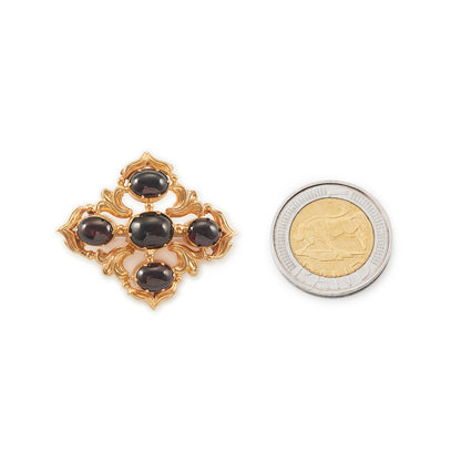 Beautiful Victorian repoussé brooch set with four cabochon Bohemian garnets. The piece can also be worn as a pendant.