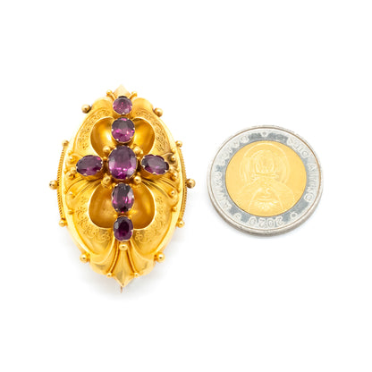 Magnificent Victorian 18ct yellow gold Etruscan brooch set with seven beautifully faceted purplish-red almandine garnets.
