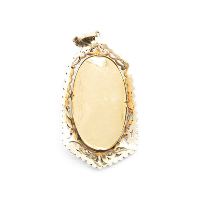 Beautifully hand-painted Victorian Madonna pendant set in an ornate, floral 18ct gold and silver frame.