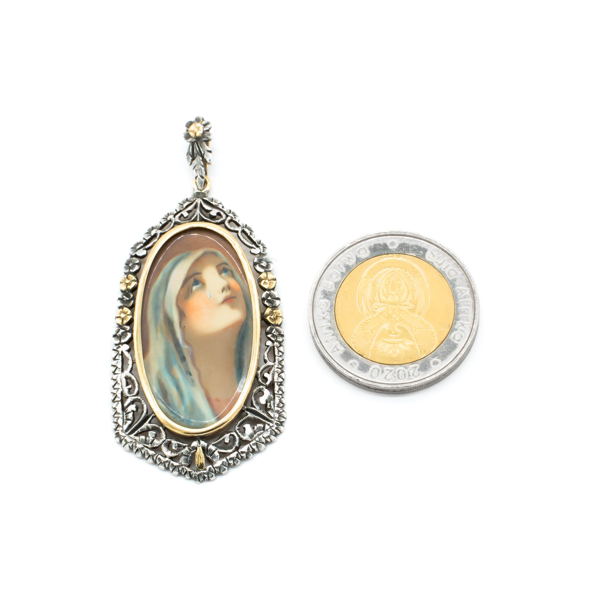 Beautifully hand-painted Victorian Madonna pendant set in an ornate, floral 18ct gold and silver frame.