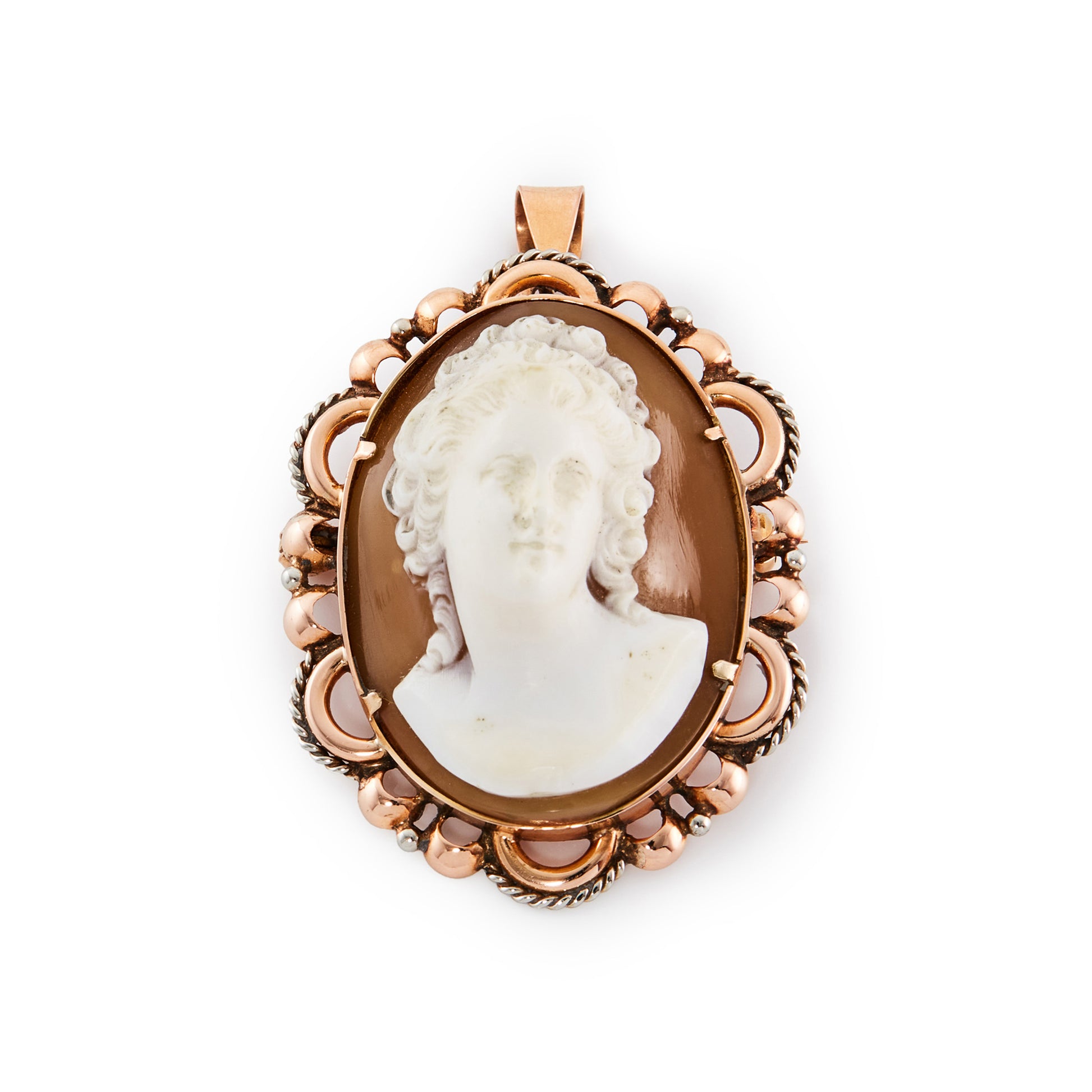 Stunning Victorian 18ct rose gold pendant set with a finely carved, high relief cameo with silver scroll work around the edges. This piece can also be worn as a brooch.