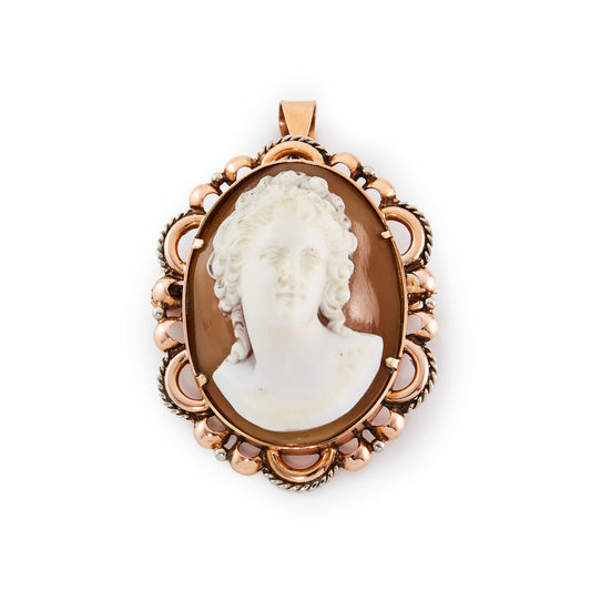 Stunning Victorian 18ct rose gold pendant set with a finely carved, high relief cameo with silver scroll work around the edges. This piece can also be worn as a brooch.