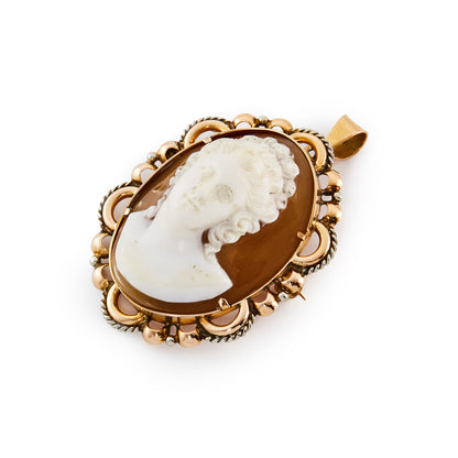 Stunning Victorian 18ct rose gold pendant set with a finely carved, high relief cameo with silver scroll work around the edges. This piece can also be worn as a brooch.