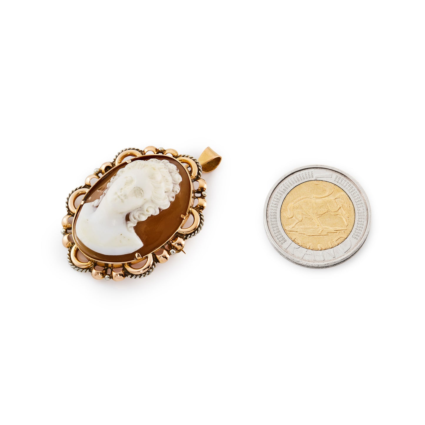 Stunning Victorian 18ct rose gold pendant set with a finely carved, high relief cameo with silver scroll work around the edges. This piece can also be worn as a brooch.