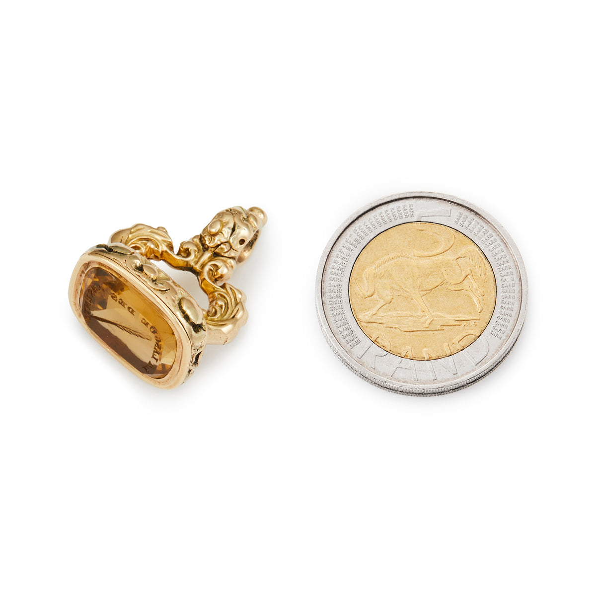Very ornate Victorian 9ct gold fob seal with a citrine intaglio depicting a feather and Latin writing in an ornate setting. 