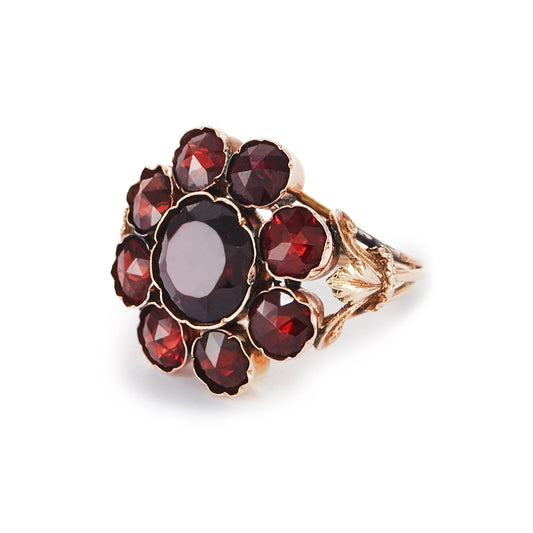 Spectacular Victorian 9ct gold cocktail ring with nine deep red Bohemian garnets in a cluster setting. The ring has lovely scrollwork detail on the shoulders.
