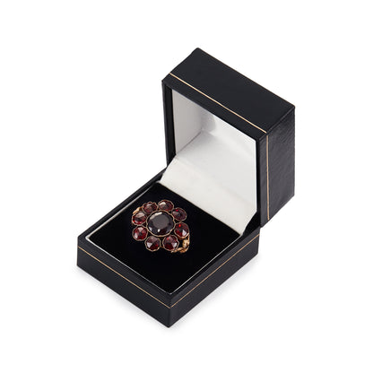 Spectacular Victorian 9ct gold cocktail ring with nine deep red Bohemian garnets in a cluster setting. The ring has lovely scrollwork detail on the shoulders.
