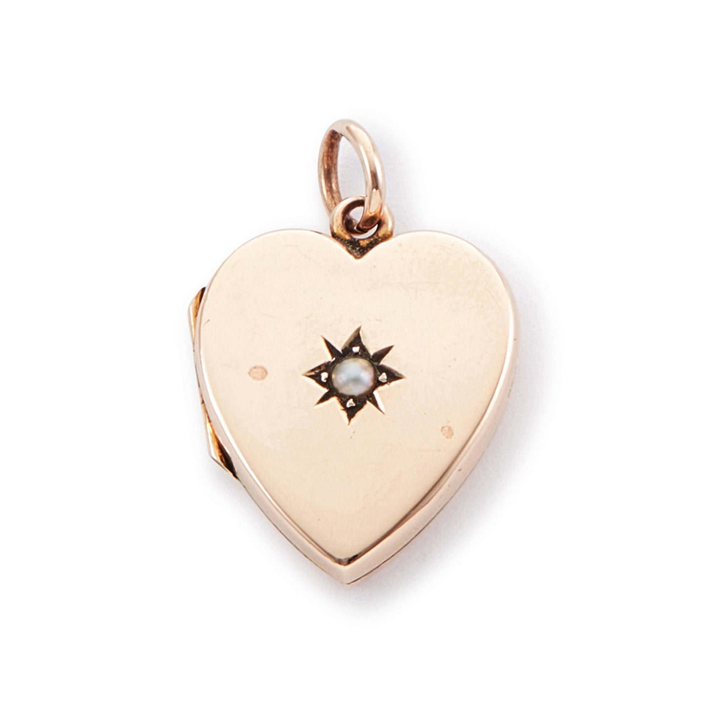 Pretty 9ct rose gold Victorian locket in the shape of a heart, adorned with a single seed pearl. The locket is inscribed with a fancy script monogram at the back. Can hold two photos inside.