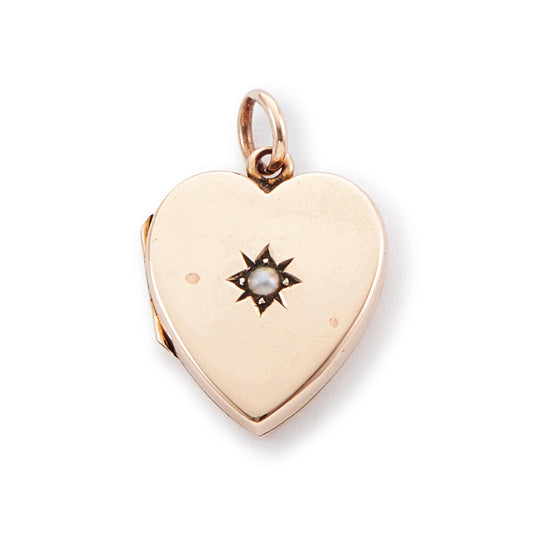 Pretty 9ct rose gold Victorian locket in the shape of a heart, adorned with a single seed pearl. The locket is inscribed with a fancy script monogram at the back. Can hold two photos inside.