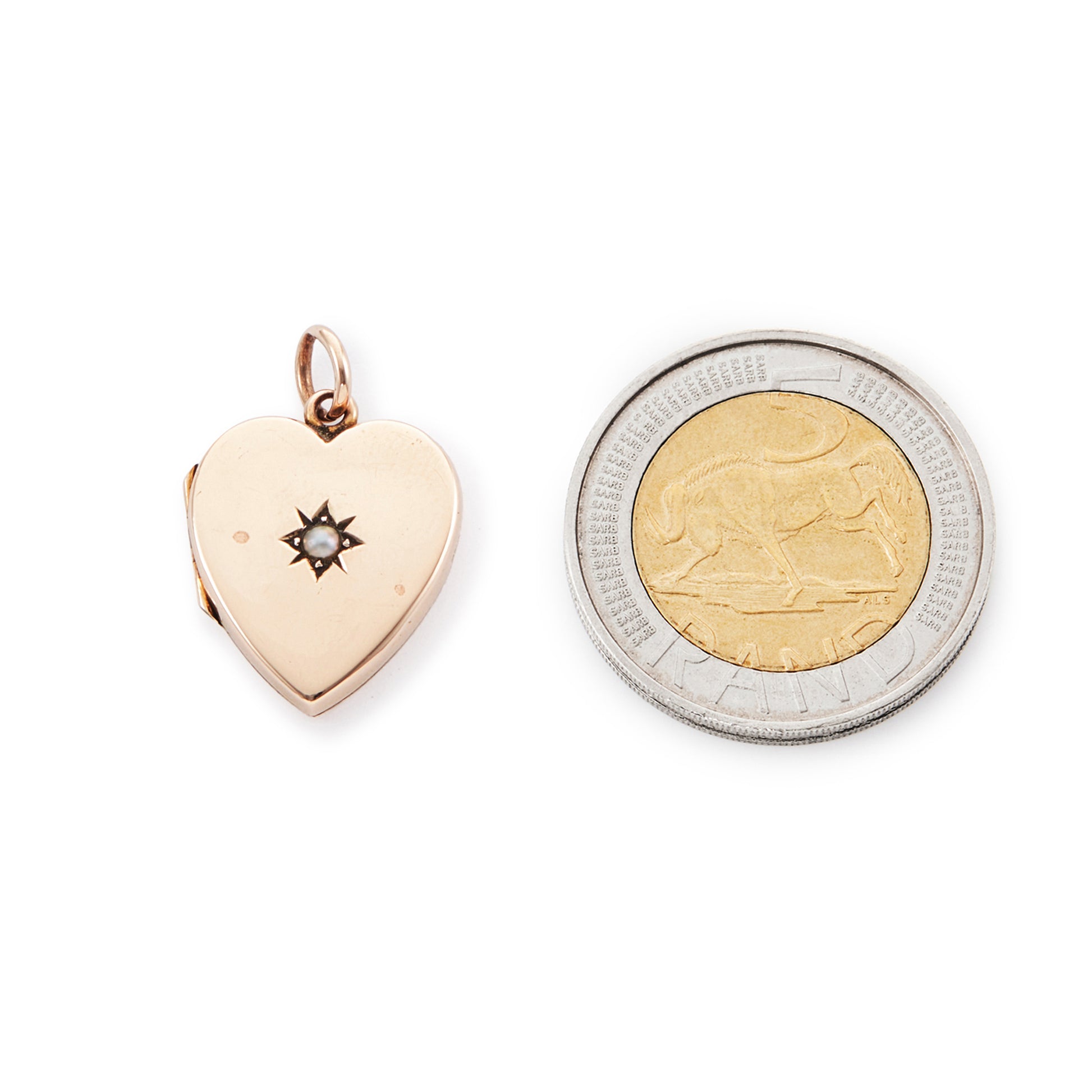 Pretty 9ct rose gold Victorian locket in the shape of a heart, adorned with a single seed pearl. The locket is inscribed with a fancy script monogram at the back. Can hold two photos inside.