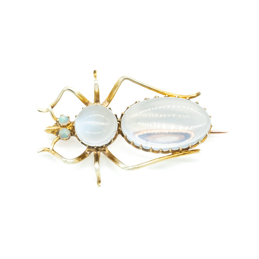 Charming Victorian 9ct gold insect brooch with a moonstone cabochon body, and fluorescent opal eyes.