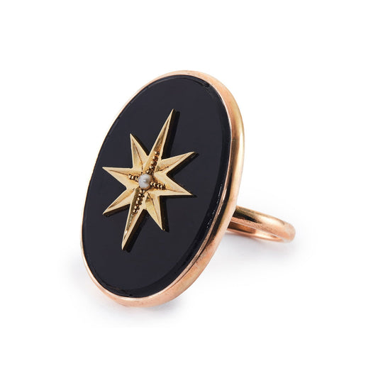 Magnificent 9ct rose gold ring set with a Victorian oval onyx disk, embellished with a 15ct yellow gold star and centre seed pearl. Later shank.