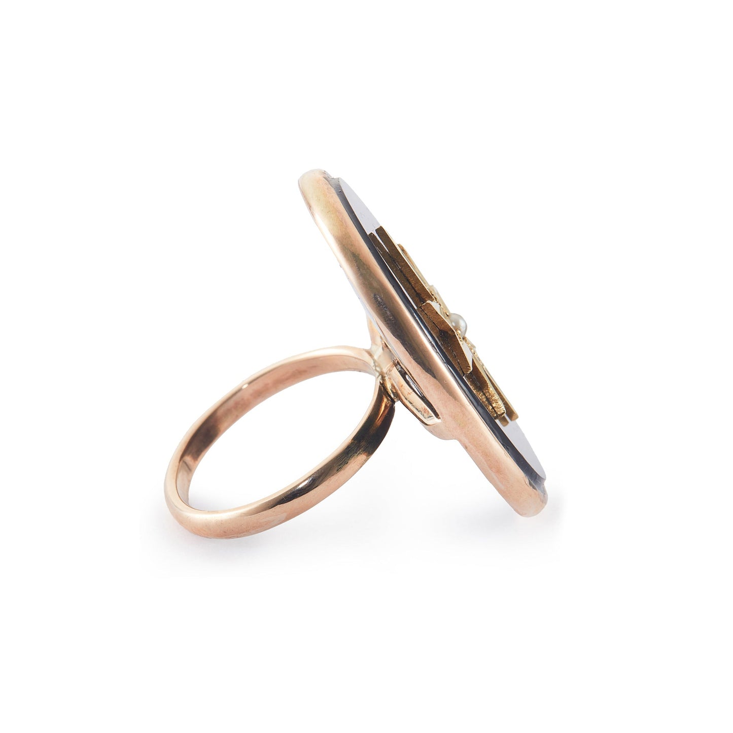 Magnificent 9ct rose gold ring set with a Victorian oval onyx disk, embellished with a 15ct yellow gold star and centre seed pearl. Later shank.