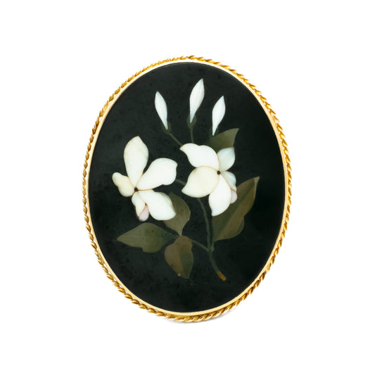 Sought-After Victorian 9ct gold natural stone Pietra Dura brooch depicting white flowers and dark green leaves.