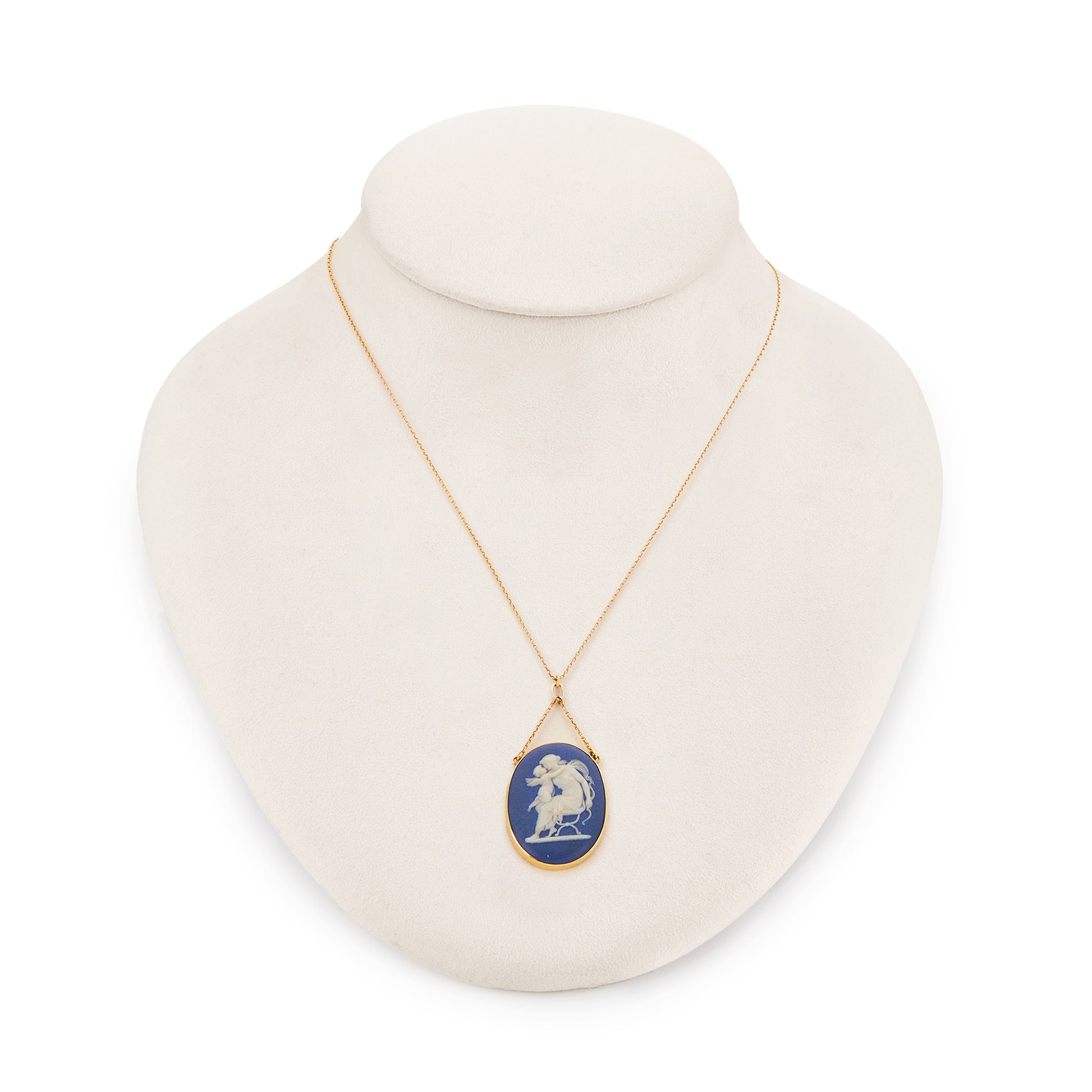 Pretty Victorian 9ct yellow gold pendant, tube-set with a beautiful blue Wedgwood cameo depicting Artemis/Diana embracing a cherub, on a dainty 9ct gold chain.