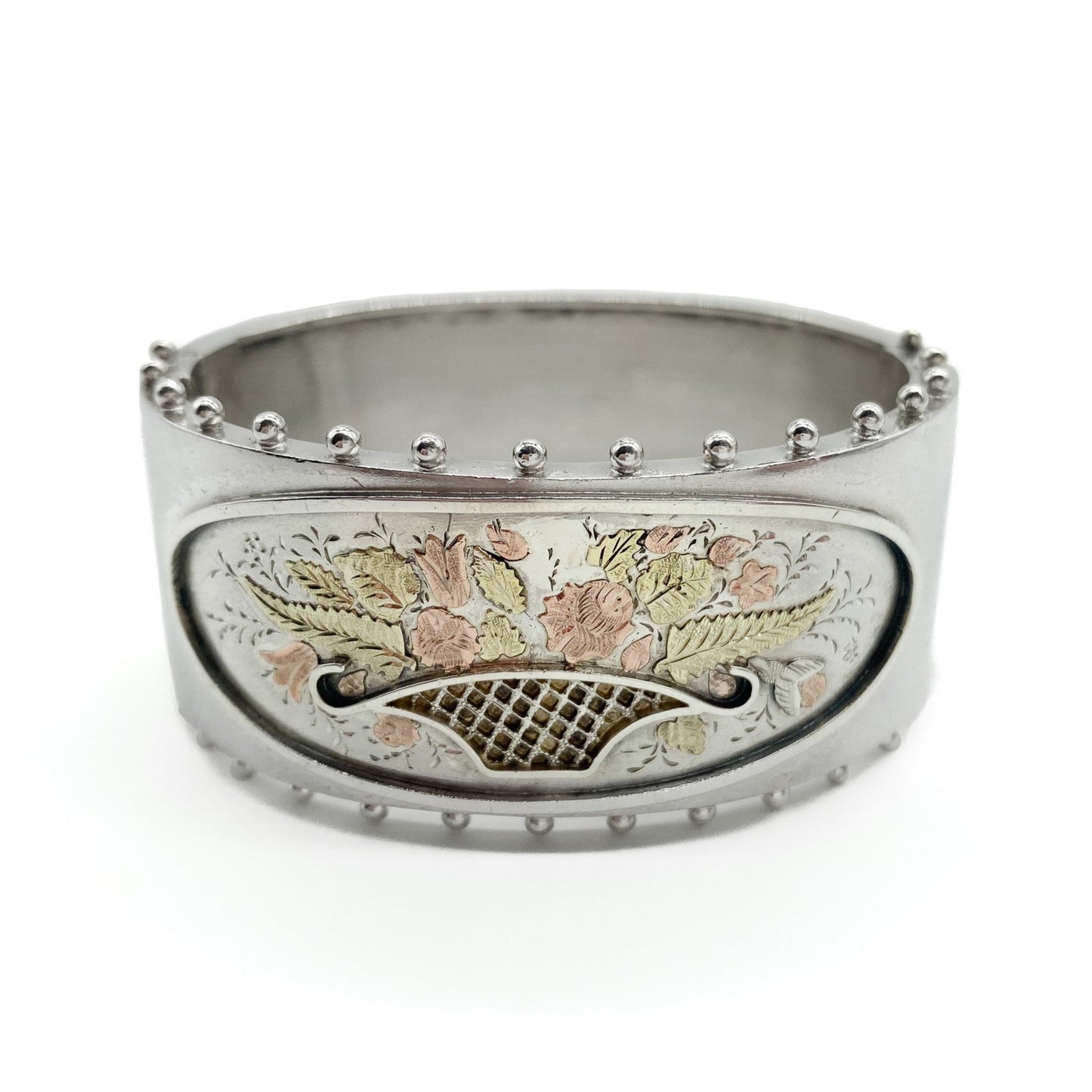 Lovely Victorian sterling silver bangle embossed with a floral bouquet in 9ct rose and yellow gold.