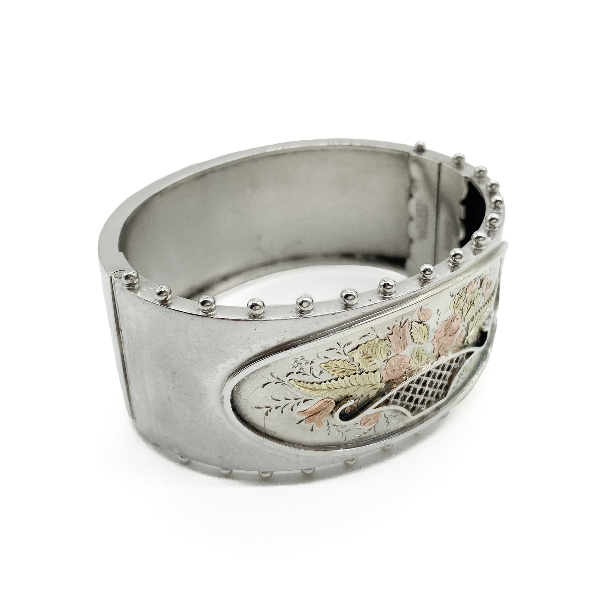 Lovely Victorian sterling silver bangle embossed with a floral bouquet in 9ct rose and yellow gold.