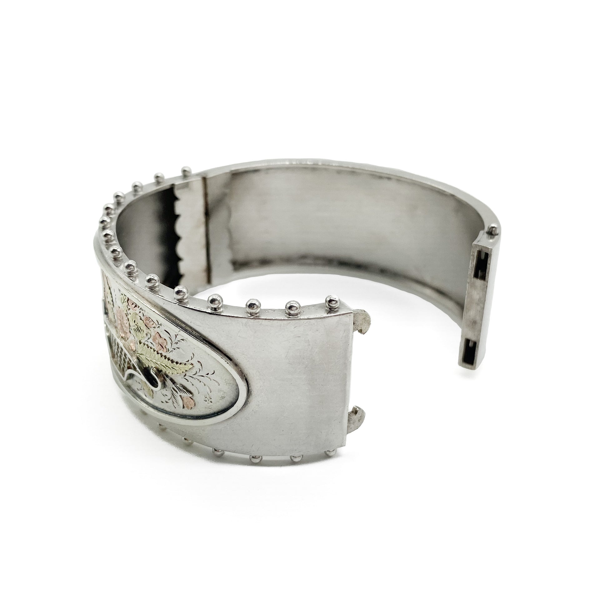 Lovely Victorian sterling silver bangle embossed with a floral bouquet in 9ct rose and yellow gold.