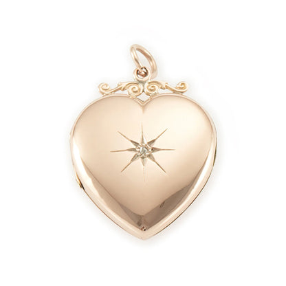 Lovely Victorian rose gold back and front puffy heart locket with a small mine-cut diamond in a star setting. Locket can take two photographs.