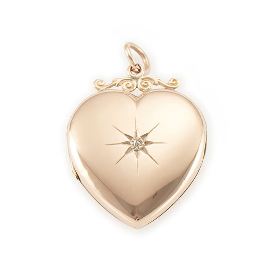 Lovely Victorian rose gold back and front puffy heart locket with a small mine-cut diamond in a star setting. Locket can take two photographs.