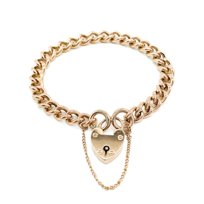 Classic Victorian 9ct solid rose gold curb link bracelet with a padlock and safety chain.