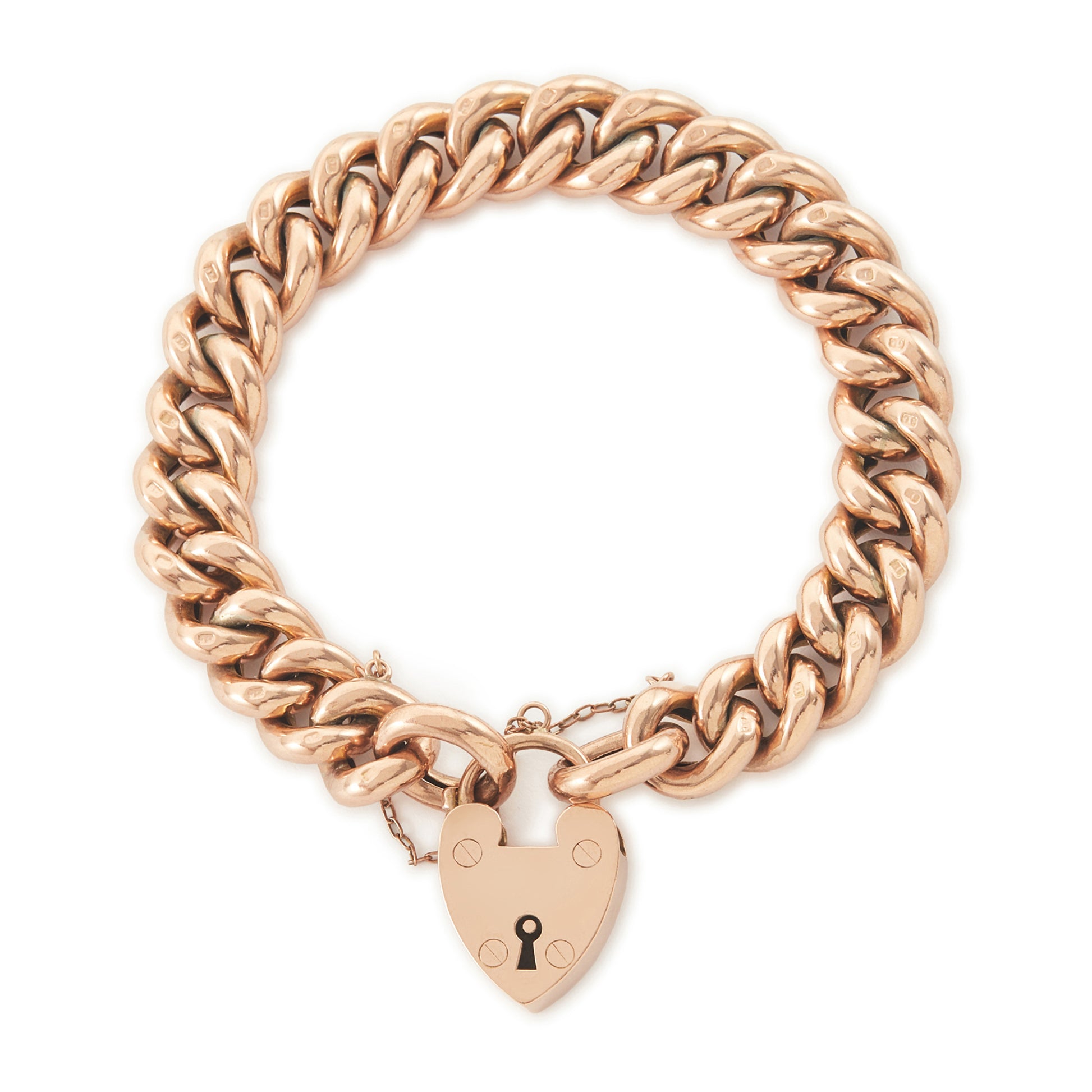 Classic Victorian 9ct rose gold curb link bracelet with a padlock and safety chain. The bracelet is plain on one side and with ornate engraving on the reverse side.