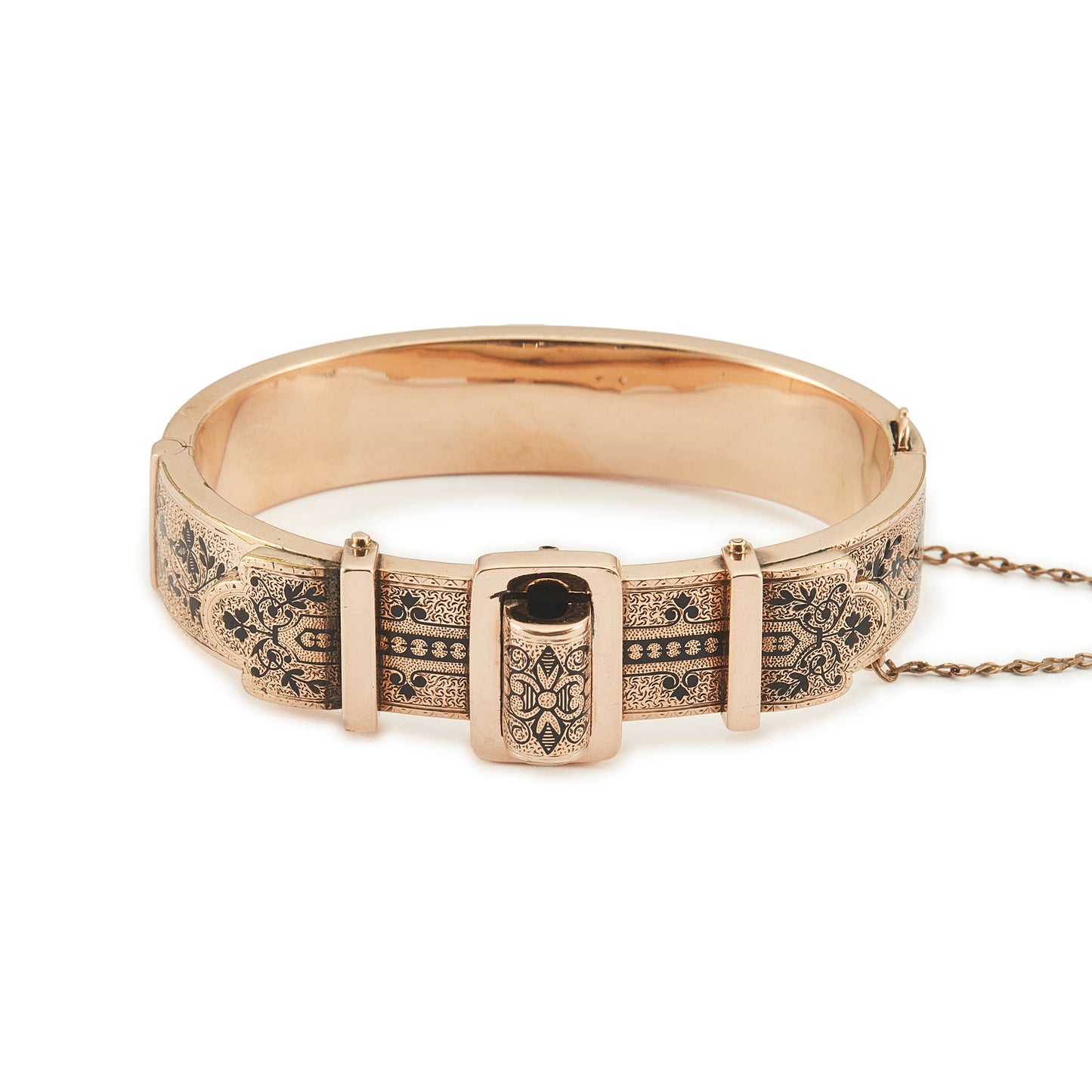 Exquisite Victorian 9ct rose gold hollow buckle bangle, embellished with beautiful intricate black enamel floral design. Opens with hinge mechanism. Safety chain attached.