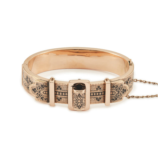 Exquisite Victorian 9ct rose gold hollow buckle bangle, embellished with beautiful intricate black enamel floral design. Opens with hinge mechanism. Safety chain attached.